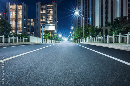 New asphalt road and cityscape at night