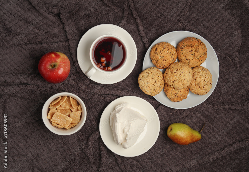 Breakfast in bed. Food on a dark blanket. Top view Breakfast in bed. Food on a dark blanket. Top view