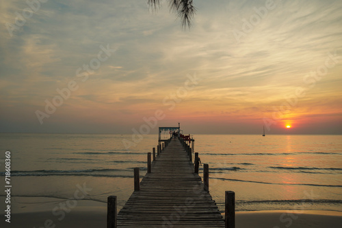 beautiful sunset at the wooden jetty at the beach. Wood bridge on the sea which has walk way for travel with beautiful sky and sunshine background. © SandyHappy