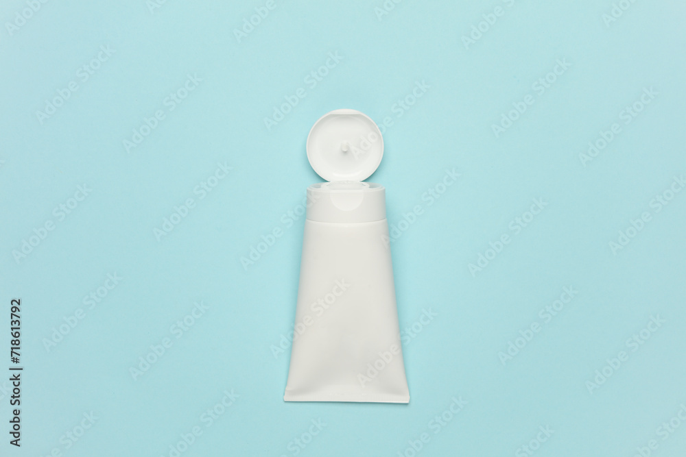 White cream tube on blue background. Cosmetics White cream tube on blue background. Cosmetics