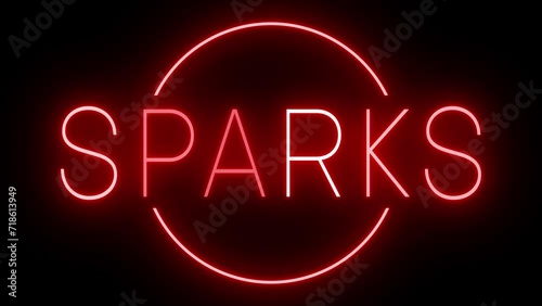 Flickering red retro style neon sign glowing against a black background for SPARKS photo