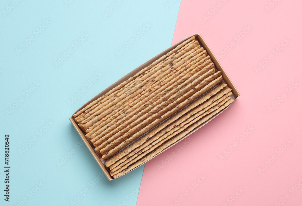 Crispy bread on pink blue background. Top view