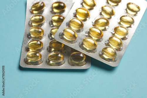 Blisters of fish oil pills on a blue background