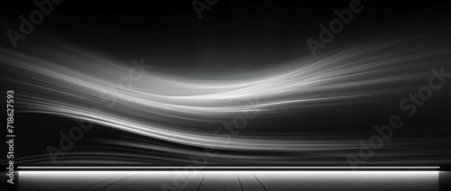 An abstract background in black  dark gray  silver  and white  featuring undulating waves and a subtle ombre gradient.