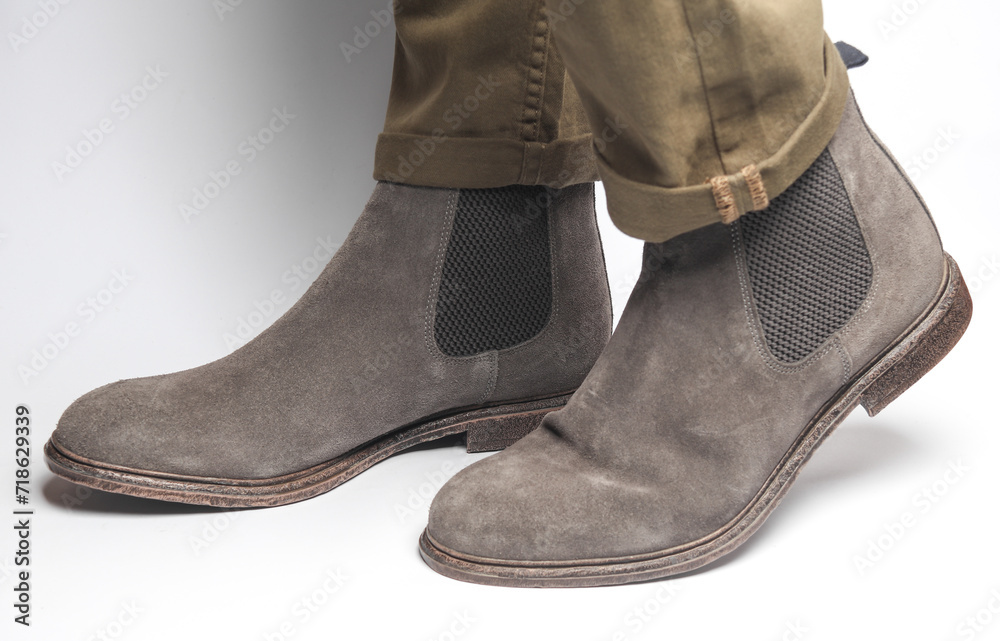 Man in suede Chelsea boots on a white background
