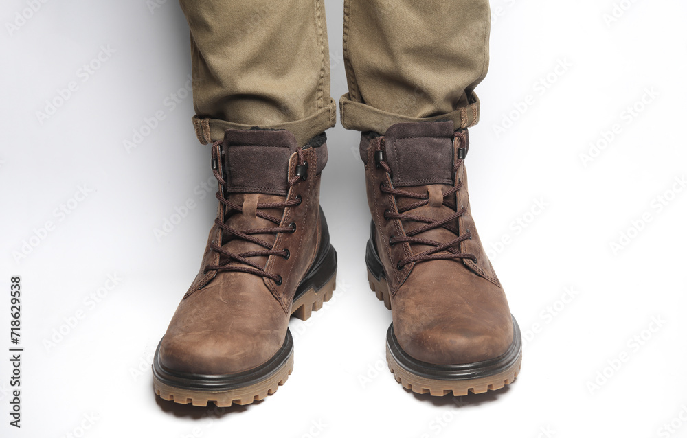 Male legs in warm winter boots on a white background. Army style
