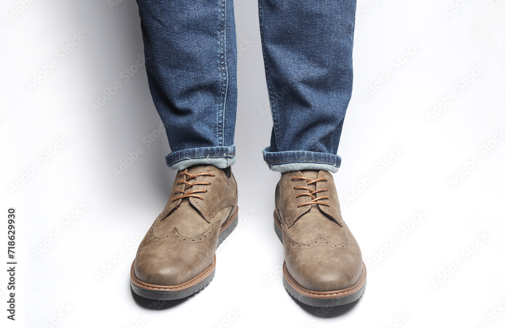 Male legs in brogue shoes on a white background Male legs in brogue shoes on a white background