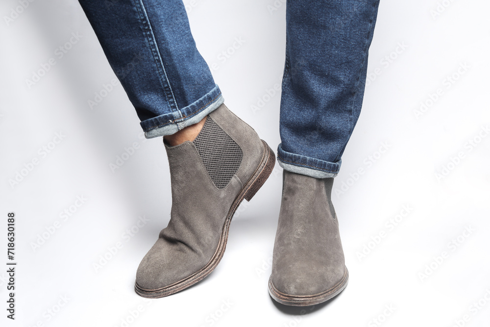Man's legs in suede Chelsea boots on a white background Man's legs in suede Chelsea boots on a white background
