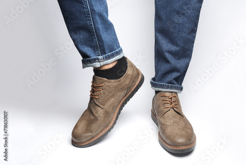 Male legs in brogue shoes on a white background
