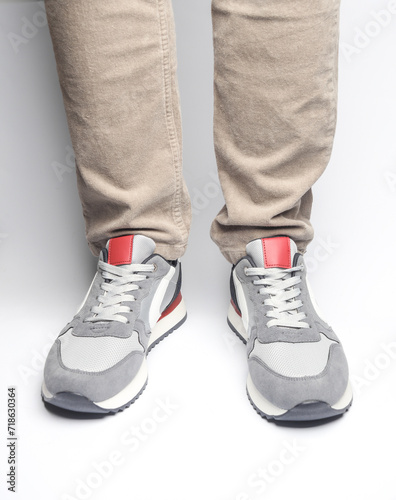 Male legs in sneakers on a white background