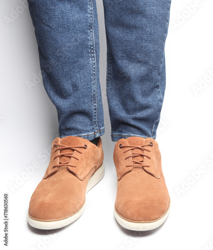Male legs in suede shoes on a white background