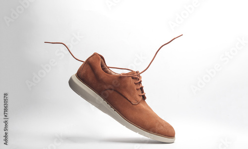 Suede shoes with flying laces on a white background photo