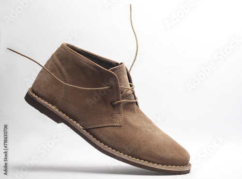 Suede shoes with flying laces on a white background