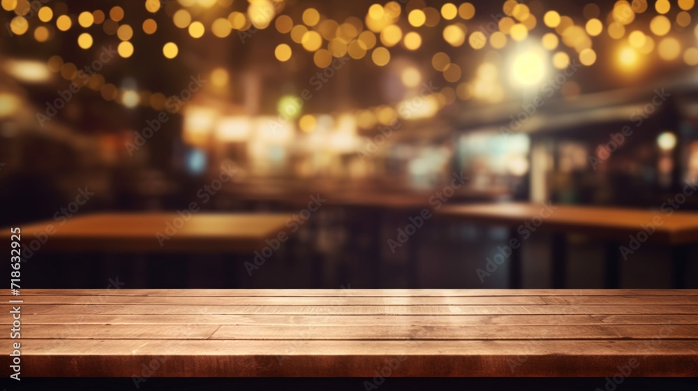 Empty wooden tabletop with a warm, blurred bar and bokeh lights in the background.