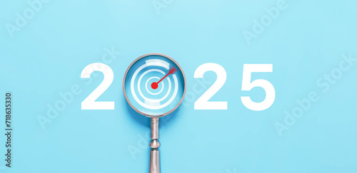 magnifying glass shows target 2025, action business plan for the new year's growth. concept of budget, finance goal to success, Making a profit in the investment market in growth industry technology photo
