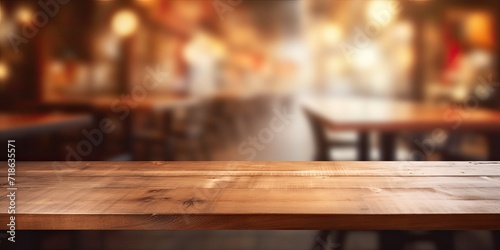 Blurred coffee shop cafe or workplace background with an empty wooden table.