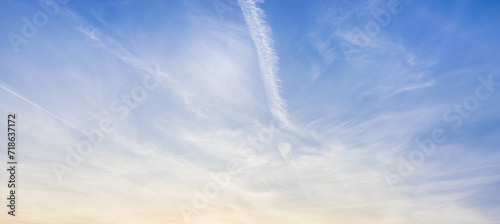 Fototapeta Naklejka Na Ścianę i Meble -  White clouds spread thinly in the blue sky - artificial cloud, contrail