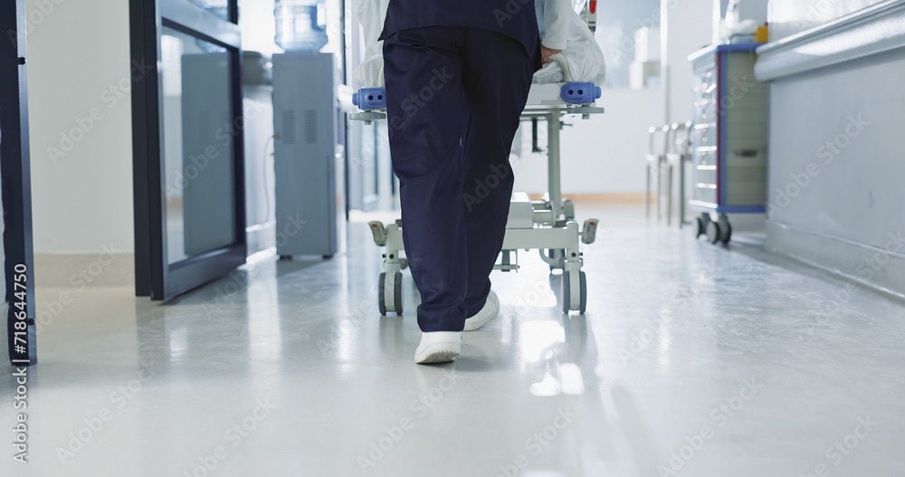Fototapeta premium Nurse, feet and walking patient in hospital, bed or steps in hallway or corridor to surgery, operation room or ER healthcare. Doctor, moving and pushing person in clinic to ICU, bedroom or walk