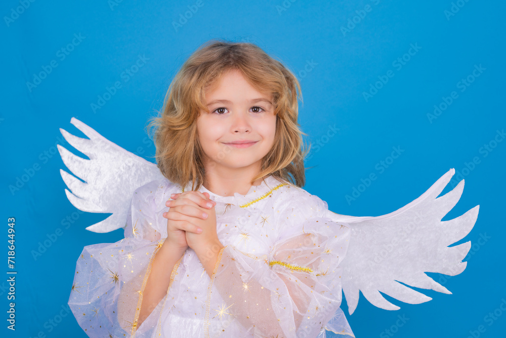 Beautiful little angel. Isolated studio shot. Cute Pretty child with angel wings with prayer hands, hope and pray concept. Cupid, valentines day concept. Beautiful little angel. Isolated studio shot. Cute Pretty child with angel wings with prayer hands, hope and pray concept. Cupid, valentines day concept.