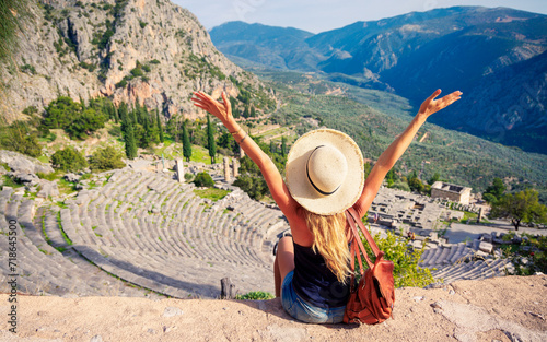 Traveler woman enjoying panoramic view of Ancient Theater in Dlephi- travel, tourism, vacation in Greece
