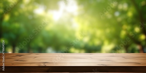 Green park background with blurred bokeh for product display on wood table top.