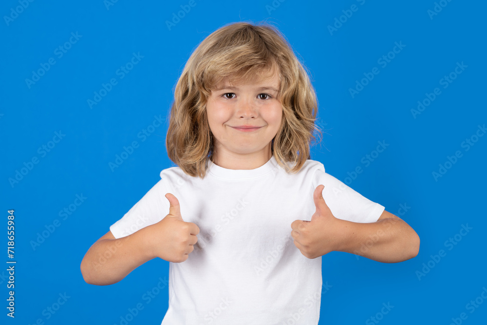 Child with thumbs up on studio isolated background. Portrait of kid boy making thumbs up sign. Child with thumbs up on studio isolated background. Portrait of kid boy making thumbs up sign.