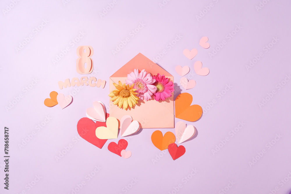 An envelope containing several flowers in different colors. Many paper hearts decorated with the word March 8 made of paper. International Women's Day is now celebrated in over 100 countries