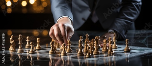 Businessman playing chess on a chessboard. Business strategy concept.