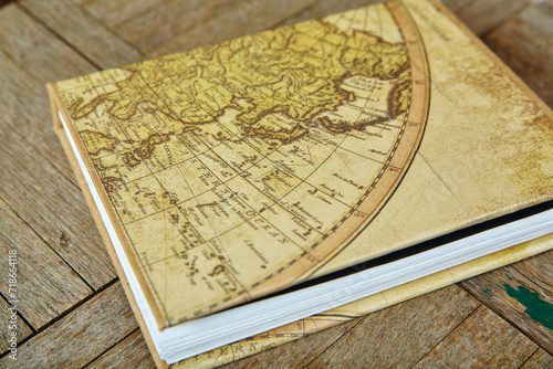 Vintage Eastern Hemisphere Map on Antique Book Cover, Rustic Wooden Texture