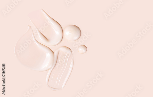 cosmetic smears texture on pastel beige background