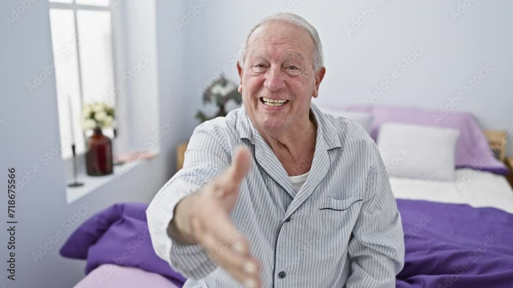 Friendly senior man in pyjamas, smiling and offering a warm handshake from bed. a symbol of successful business welcoming gestures, right from his bedroom. Friendly senior man in pyjamas, smiling and offering a warm handshake from bed. a symbol of successful business welcoming gestures, right from his bedroom.