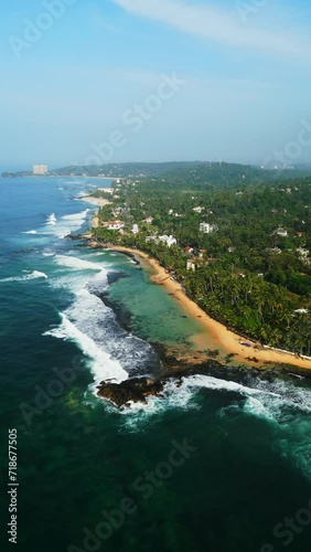 Aerial view of Dalawella beach lagoon in Sri Lanka, turquoise waters, sandy shores fringed by lush greenery, picturesque destination for travelers, nature enthusiasts seeking tranquil seaside escape. photo