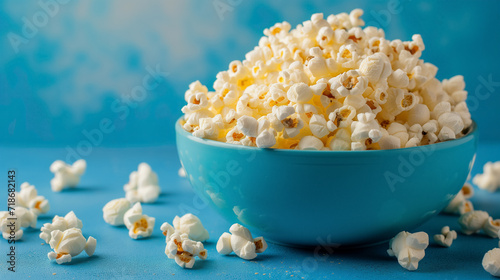 Bowl of popcorn on a vibrant blue backdrop.