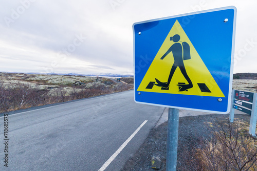a sign informing about a pedestrian crossing in diving costumes near Silfra, iThingvellir, Iceland