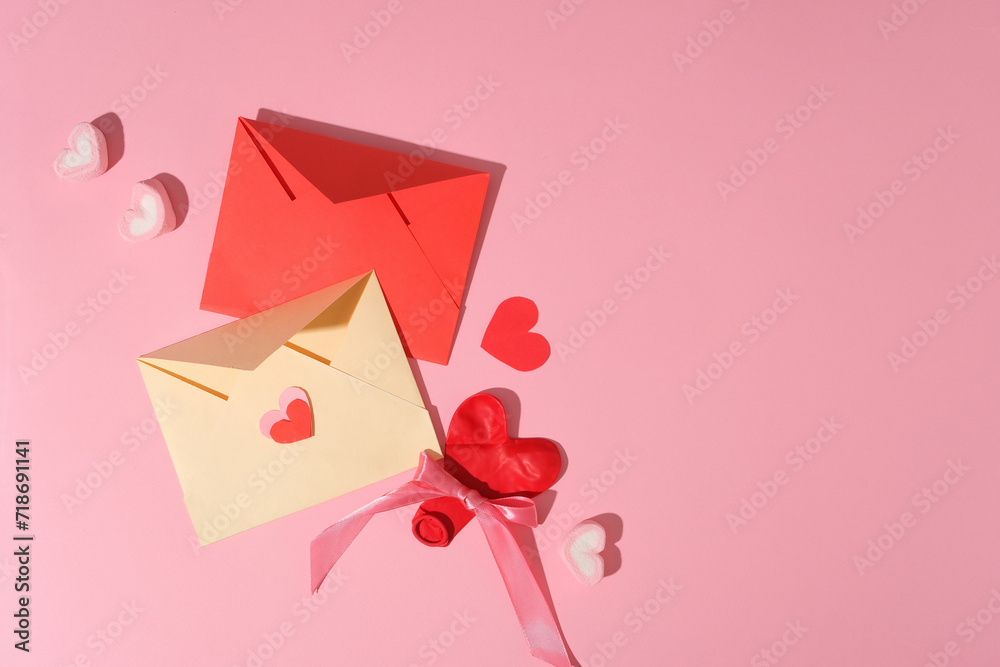 Two handmade envelopes in red and beige color displayed with marshmallow and paper hearts. Vacant space in the right corner for product promotion with Valentine or Women’s Day content Two handmade envelopes in red and beige color displayed with marshmallow and paper hearts. Vacant space in the right corner for product promotion with Valentine or Women’s Day content