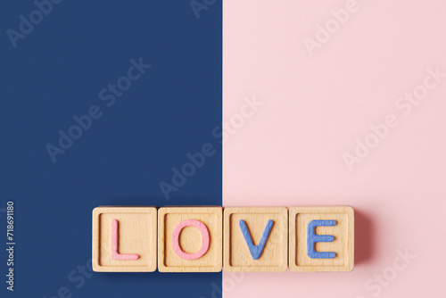 Colorful Wooden Blocks Spelling LOVE on Dual Tone Background