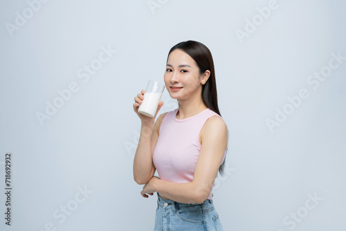 Young smiling happy fun woman hold in hand glass drink milk isolated on white background.