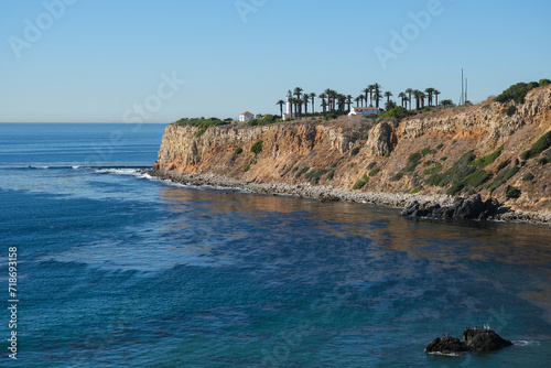Breathtaking scenic and landscape view of coastline of Rancho Palos Verdes with vegetation and cliffs and beautiful bays overlooking ocean and coast in California on sunny blue sky day photo