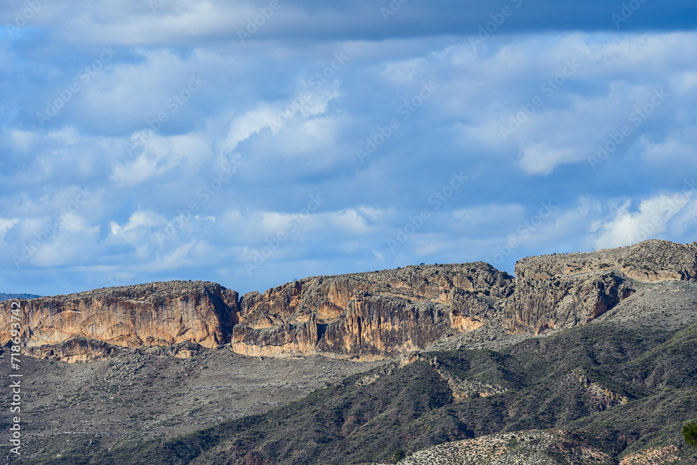 Fototapeta premium Majestic Cliff Faces Under a Dynamic Sky