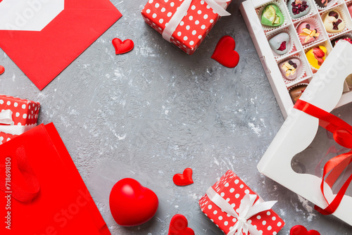 top view photo of st valentine day decor shopping, bag, envelope, gift, box, candy and red heart on colored background with empty space. Frame background