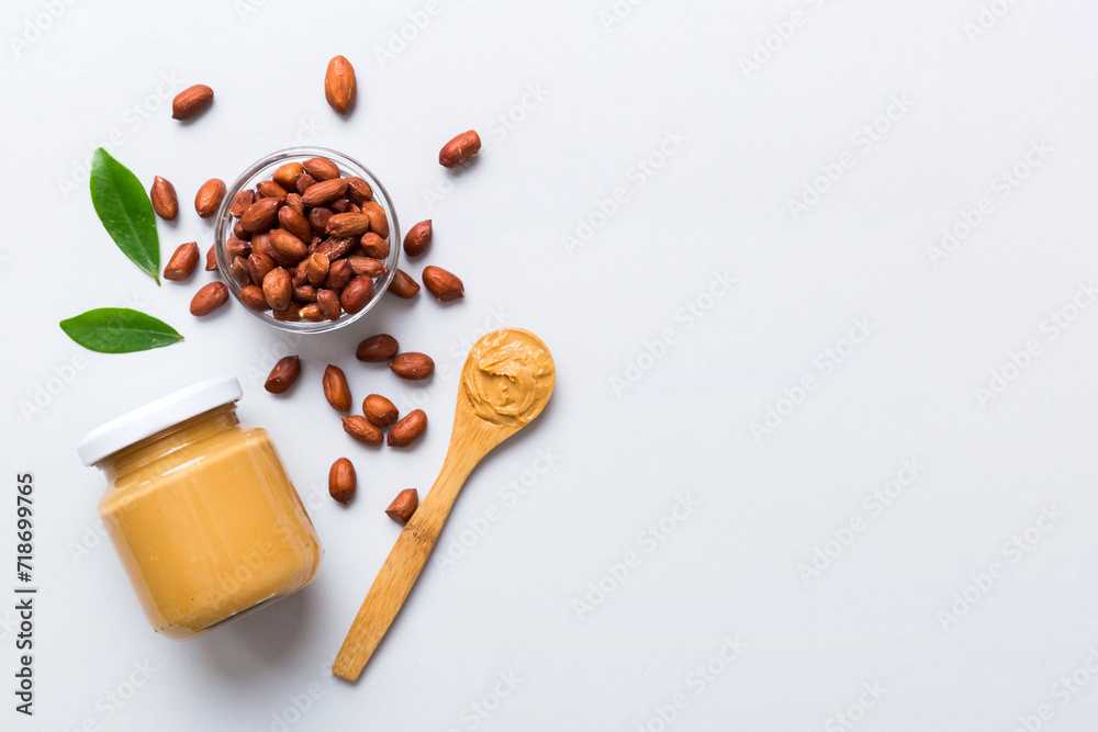 Bowl of peanut butter and peanuts on table background. top view with copy space. Creamy peanut pasta in small bowl Bowl of peanut butter and peanuts on table background. top view with copy space. Creamy peanut pasta in small bowl