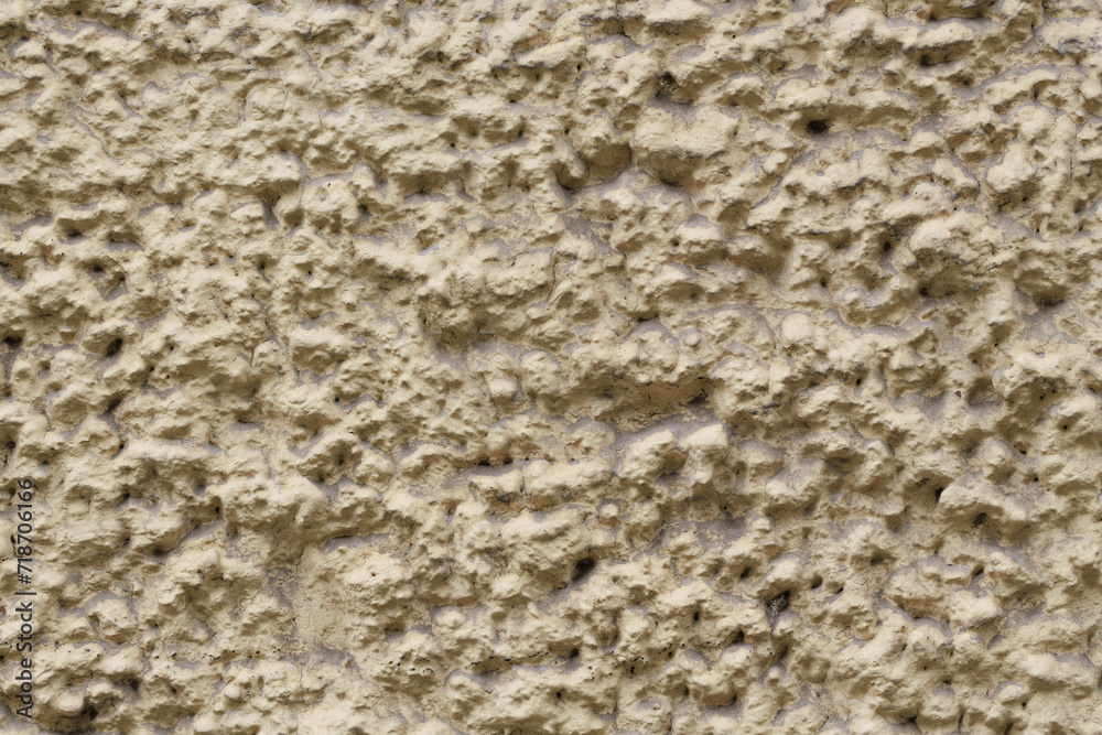 Detail of wall of sandy color and notably rough texture Detail of wall of sandy color and notably rough texture