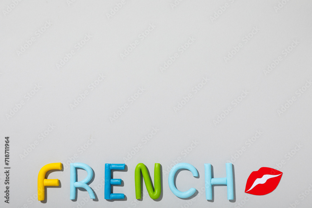 The word French on a gray background. The word French on a gray background.
