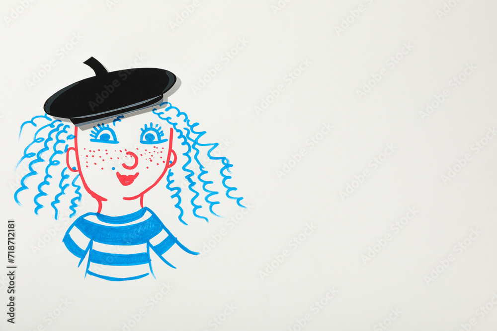 A French girl is drawn on a piece of paper with a beret on her head.