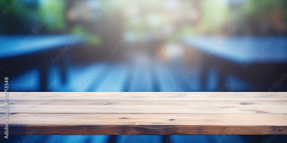 Bluish blurry background and wooden workspace Bluish blurry background and wooden workspace