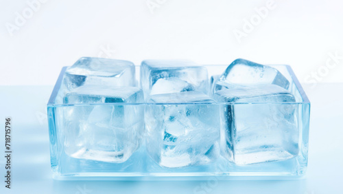 Transparent ice cubes neatly stacked in a glass container, symbolizing coolness and freshness