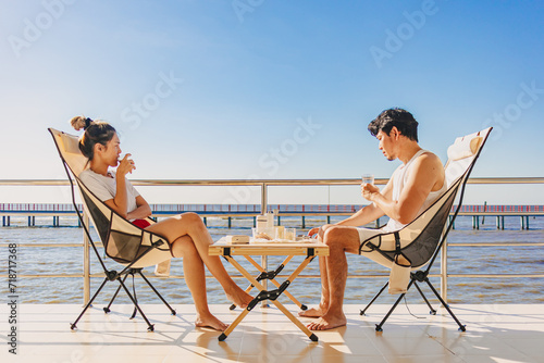 Asian couple lover enjoy their holiday at the sea in the summer with beautiful clear sky ocean. © Sevendeman