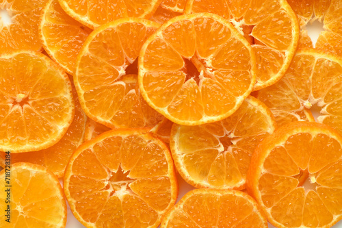 juicy and appetizing tangerines cut into circles as a food background 4
