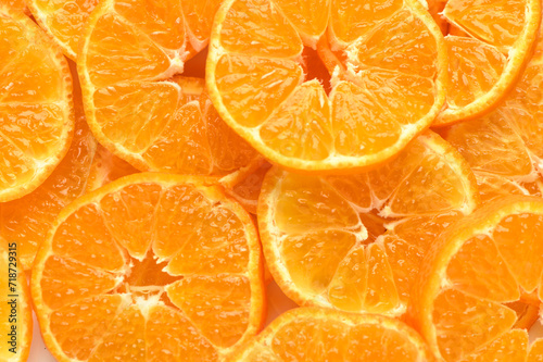 juicy and appetizing tangerines cut into circles as a food background 3
