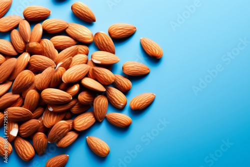 Fresh Almonds on Vibrant Blue Background - Health Concept